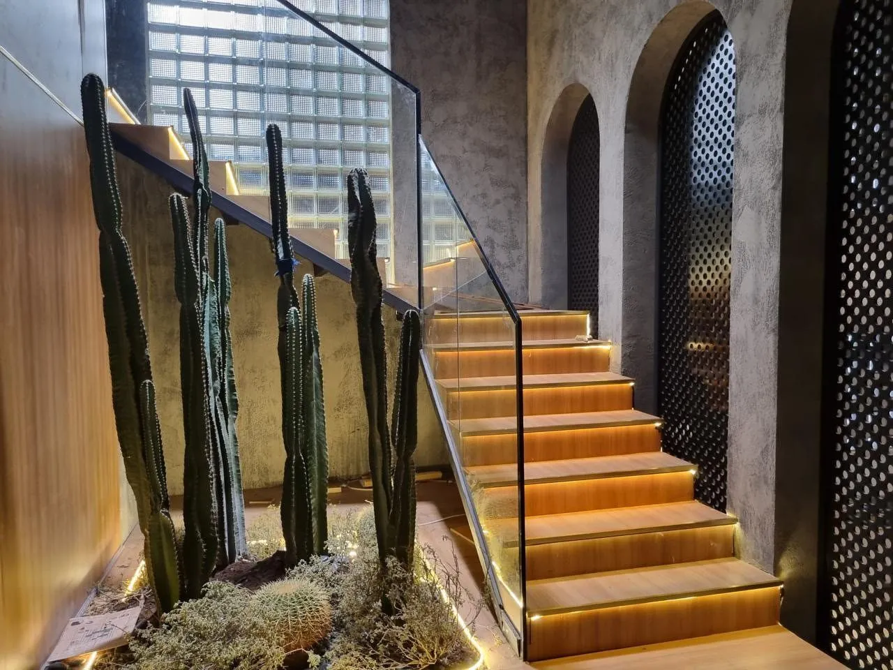Staircase with concealed lighting and a glass facade